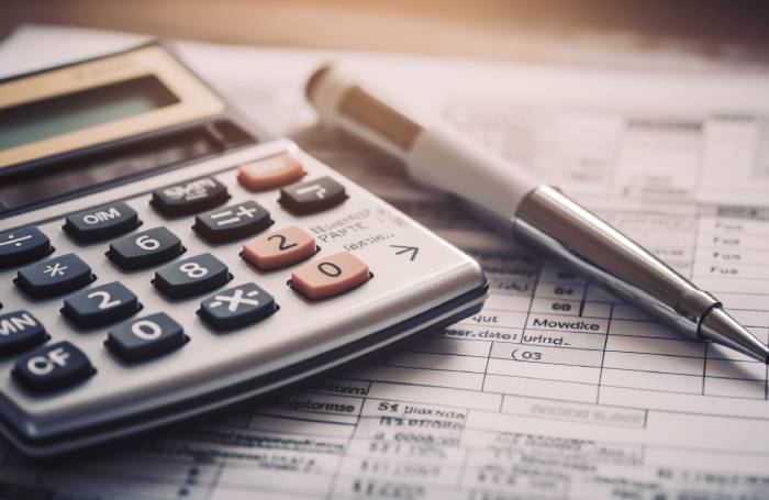 Calculator and ledgers on a desk